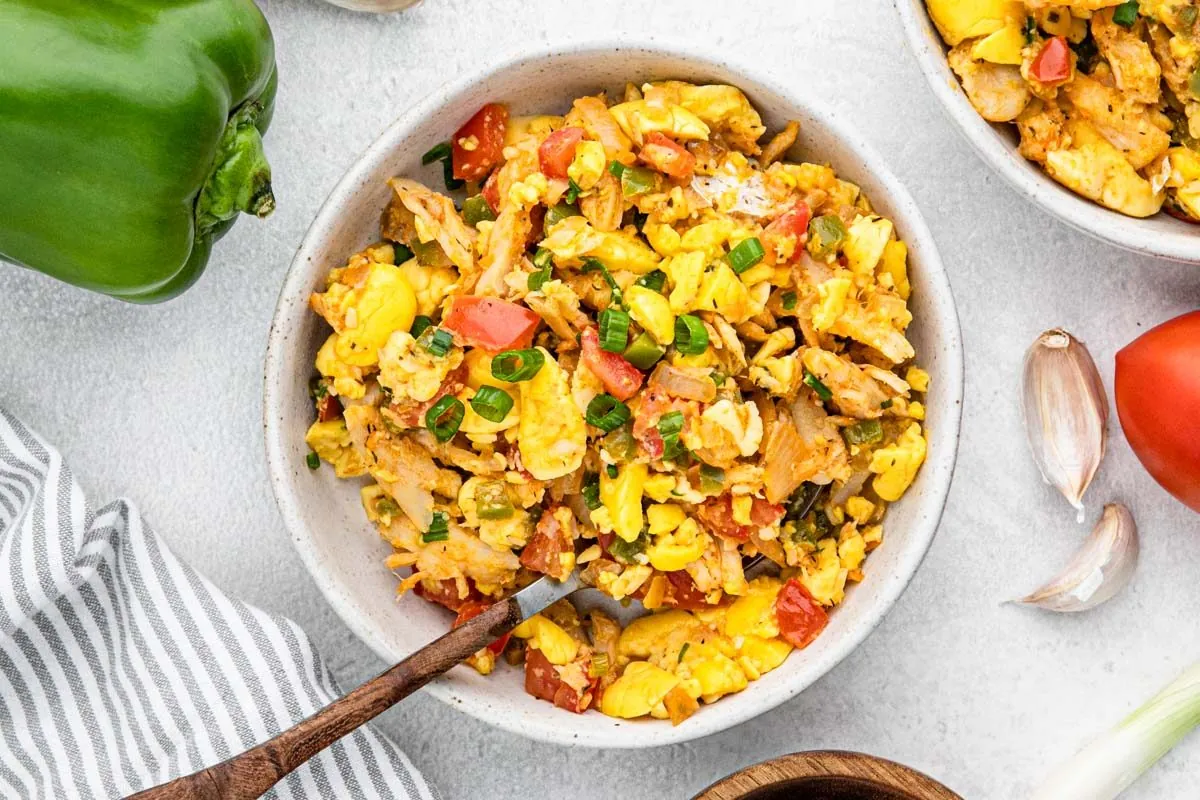 A bowl of Ackee and Saltfish with tomato, sweet pepper, and scallion