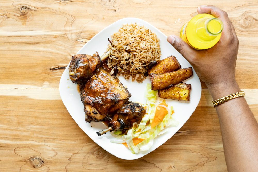 Jerk chicken with rice, plantains, and coleslaw