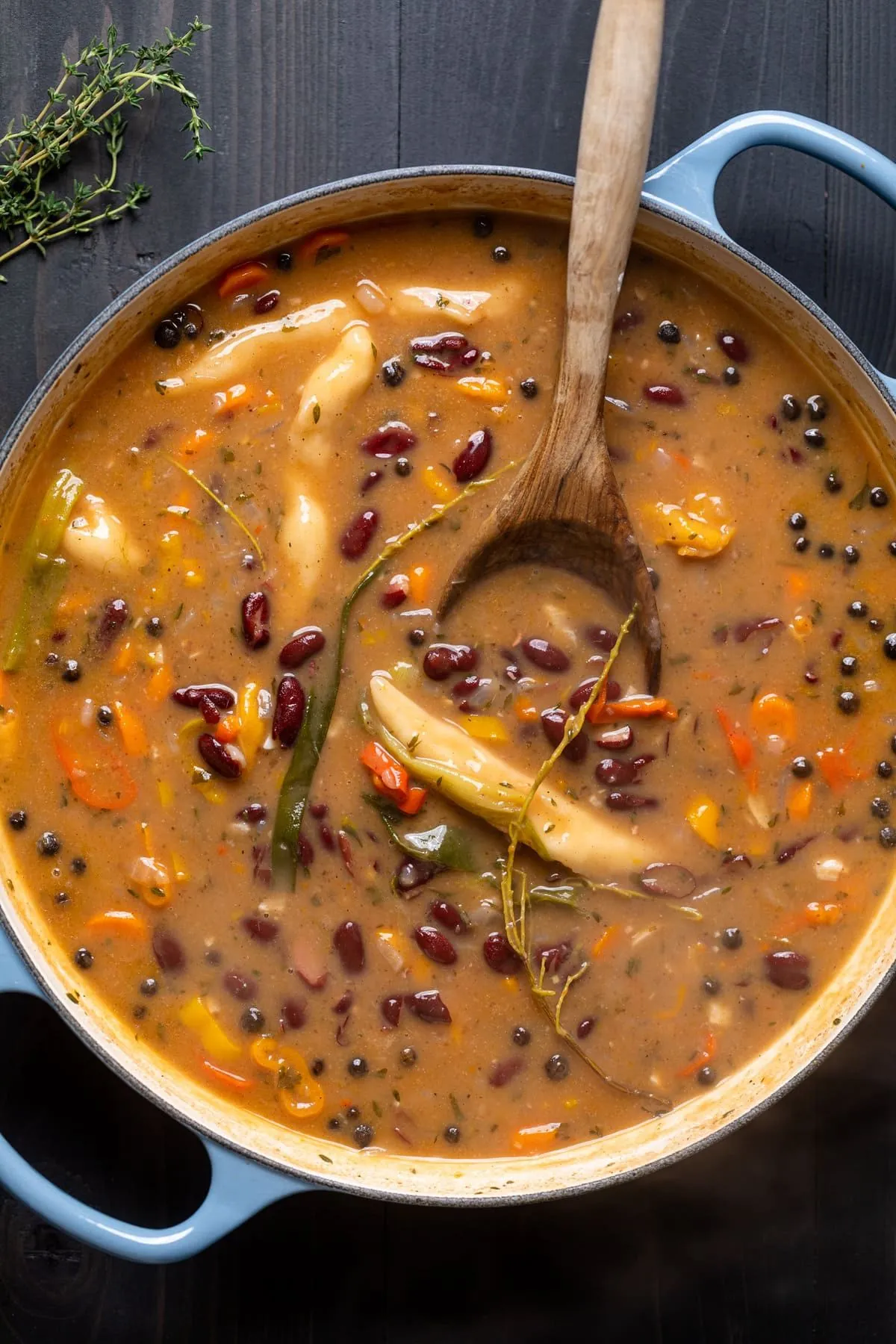 A pot of Jamaican Red Pea Soup with kidney beans, peppers, and spinner dumplings